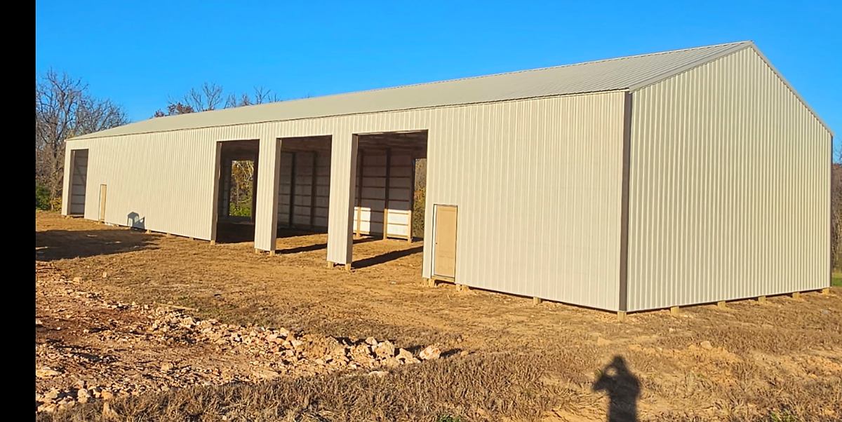 Light-colored pole barn exterior during site completion
